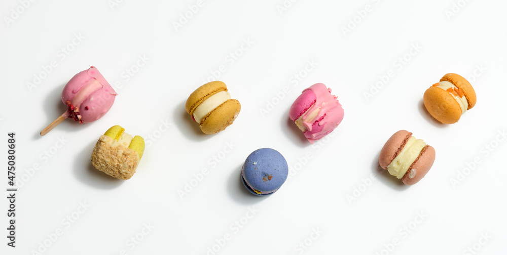 baked macarons with different flavors on a white background, top view baked macarons with different flavors on a white background, top view