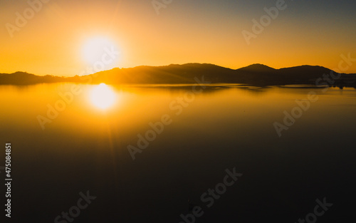 Practicing stand up pandle at sunrise at Lagoa da Concei    o in Florian  polis Santa Catarina Brazil