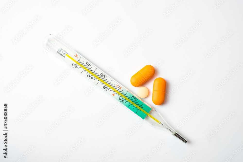 thermometer and pills isolated on white background thermometer and pills isolated on white background