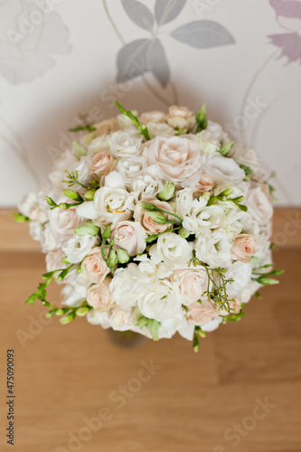 delicate wedding bouquet on background of room © Olga Mishyna