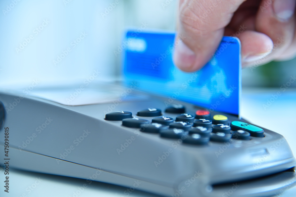 Сustomer hand makes payment by credit card. Сustomer hand makes payment by credit card.