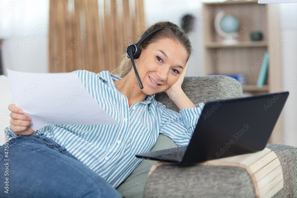 Fototapeta premium happy interpreter in headset translate write notes from home