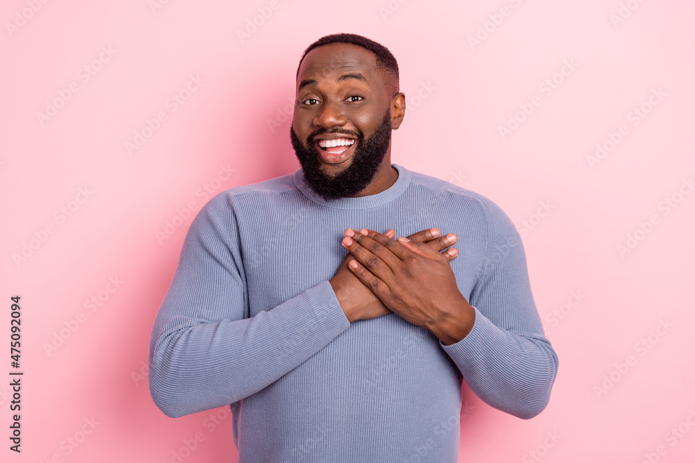 Photo of grateful sincere guy hands chest heart cardiology clinic ad wear grey shirt isolated pink color background Photo of grateful sincere guy hands chest heart cardiology clinic ad wear grey shirt isolated pink color background
