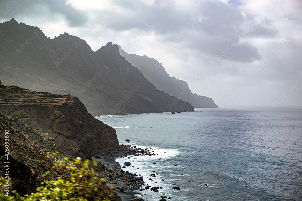 Black sand volcanic beach and view of Anaga mountains on northern coast Tenerife island, Spain Black sand volcanic beach and view of Anaga mountains on northern coast Tenerife island, Spain