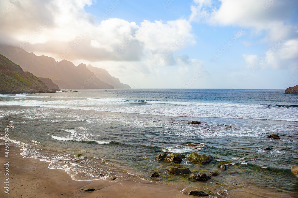 Black sand volcanic beach and view of Anaga mountains on northern coast Tenerife island, Spain