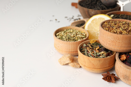 Concept of cooking tea with different types of tea on white background