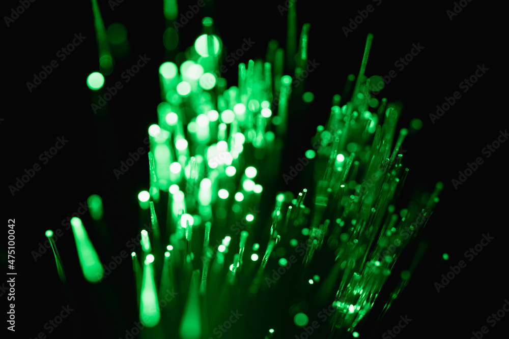 abstract green on black bokeh background overlay layer. sparks and ...