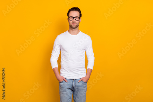 Photo of nice strict brunet millennial guy wear eyewear white outfit isolated on vibrant yellow color background