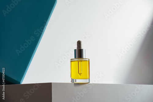 face oil on geometric teal background