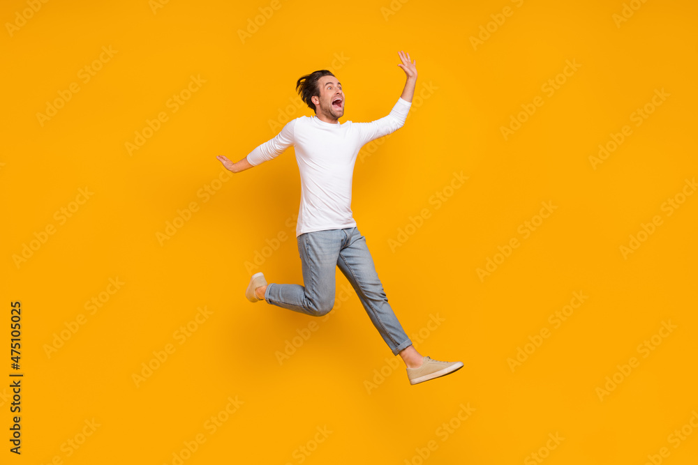 Full length photo of stressed brunet millennial guy run wear shirt jeans shoes isolated on yellow background