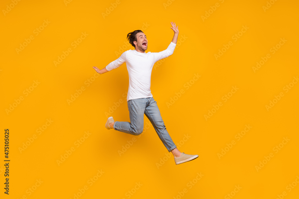 Full length photo of stressed brunet millennial guy run wear shirt jeans shoes isolated on yellow background Full length photo of stressed brunet millennial guy run wear shirt jeans shoes isolated on yellow background