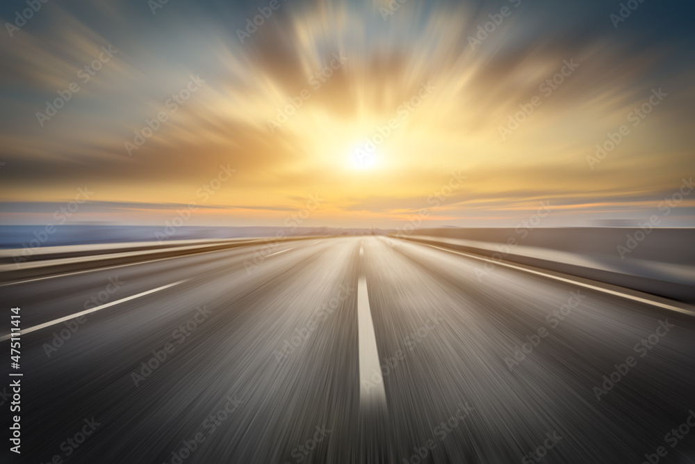 Naklejka premium Motion blurred asphalt road and beautiful clouds at sunset