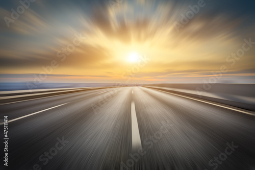 Motion blurred asphalt road and beautiful clouds at sunset © ABCDstock