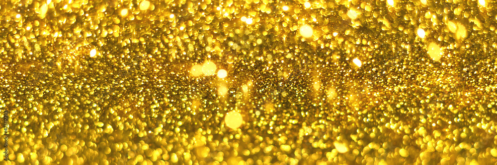 Golden sparkling glitter bokeh background, christmas texture. Holiday lights. Abstract defocused header. Wide screen wallpaper. Panoramic web banner with copy space for design Golden sparkling glitter bokeh background, christmas texture. Holiday lights. Abstract defocused header. Wide screen wallpaper. Panoramic web banner with copy space for design
