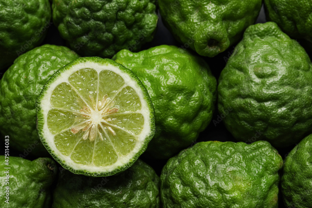 Whole and cut ripe bergamot fruits as background, top view Whole and cut ripe bergamot fruits as background, top view