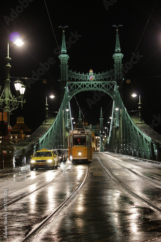 BUDAPEST, HUNGARY - december 15, 2017: yellow train on Liberty Bridge or Freedom Bridge in Budapest, Hungary