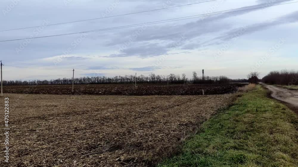 Harvested agricultural field and farm in winter without snow Harvested agricultural field and farm in winter without snow