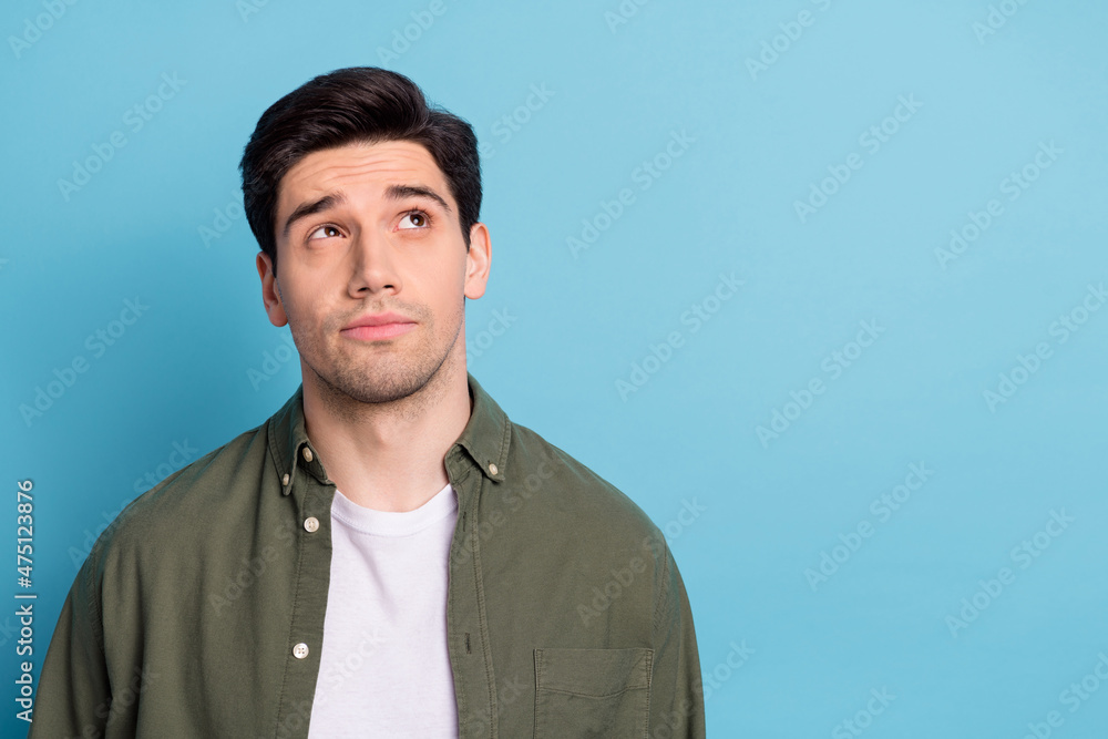 Photo of minded guy look empty space think thoughts decision isolated over sky light color background Photo of minded guy look empty space think thoughts decision isolated over sky light color background