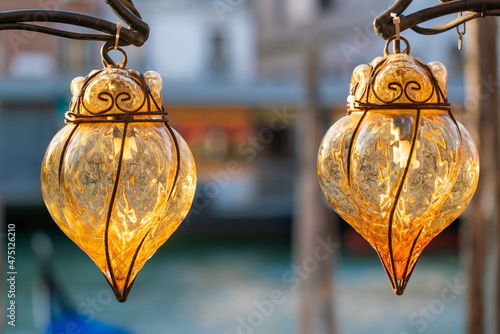 Two Venetian cage lanterns of amber Murano glass on Grand Canal