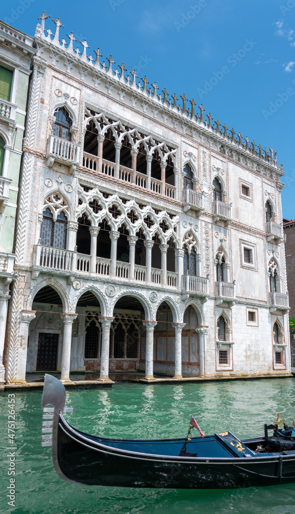 Ca' d'Oro marble palace in Venice with gondola on Grand Canal