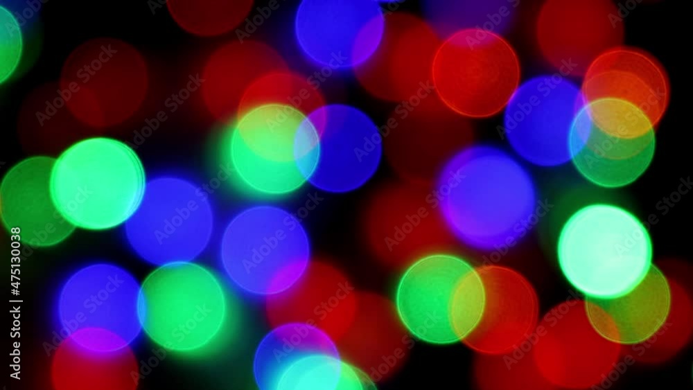 The blue-green red and orange bokeh lights flash and then go out. Light from electric garland of multicolored color, concept of new year and christmas holidays The blue-green red and orange bokeh lights flash and then go out. Light from electric garland of multicolored color, concept of new year and christmas holidays