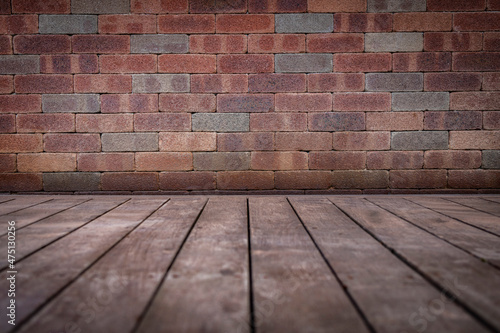 Dark brown brick wall and wooden parquet. The horizontal format is in a low angle with perspective.