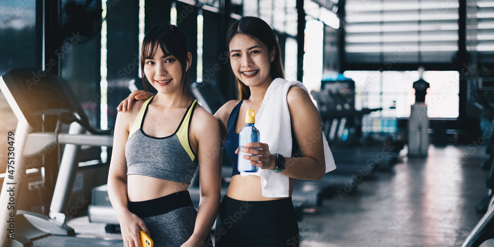 Two healthy woman standing at gym after yoga class. Gym, fitness, healthy concept. Two healthy woman standing at gym after yoga class. Gym, fitness, healthy concept.