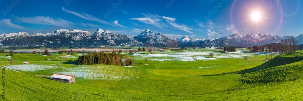 panoramic view to alps mountain range and lake Forggensee in Bavaria