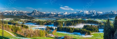 panoramic view to alps mountain range and lake Forggensee in Bavaria