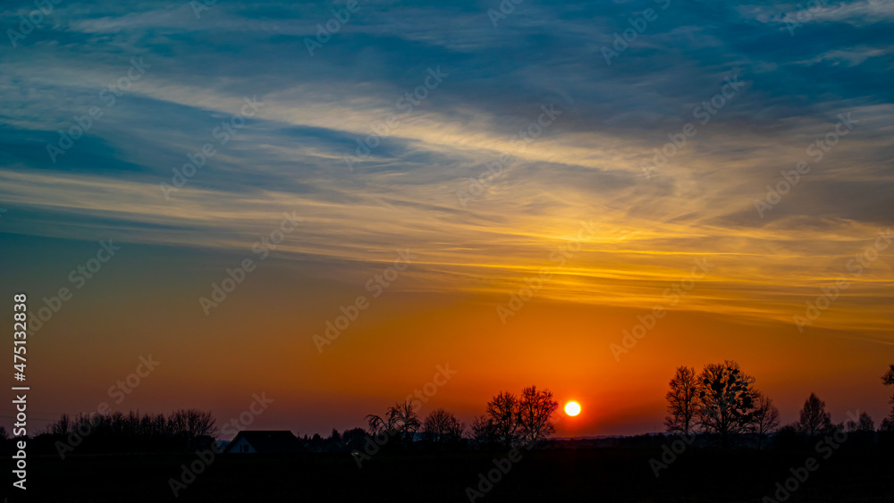 sunset panorama sky. sunset over a forest in Poland
