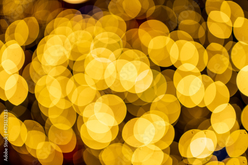 Abstract Golden yellow bokeh background. Beautiful blurry lights in horizontal format.