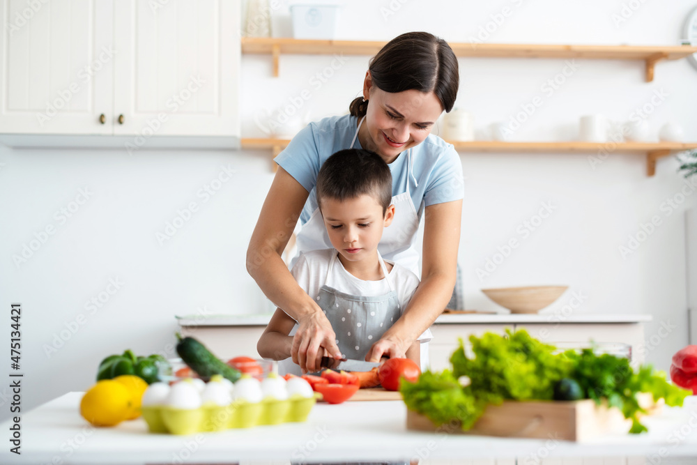 Cheerful mother helping her son to cook Cheerful mother helping her son to cook