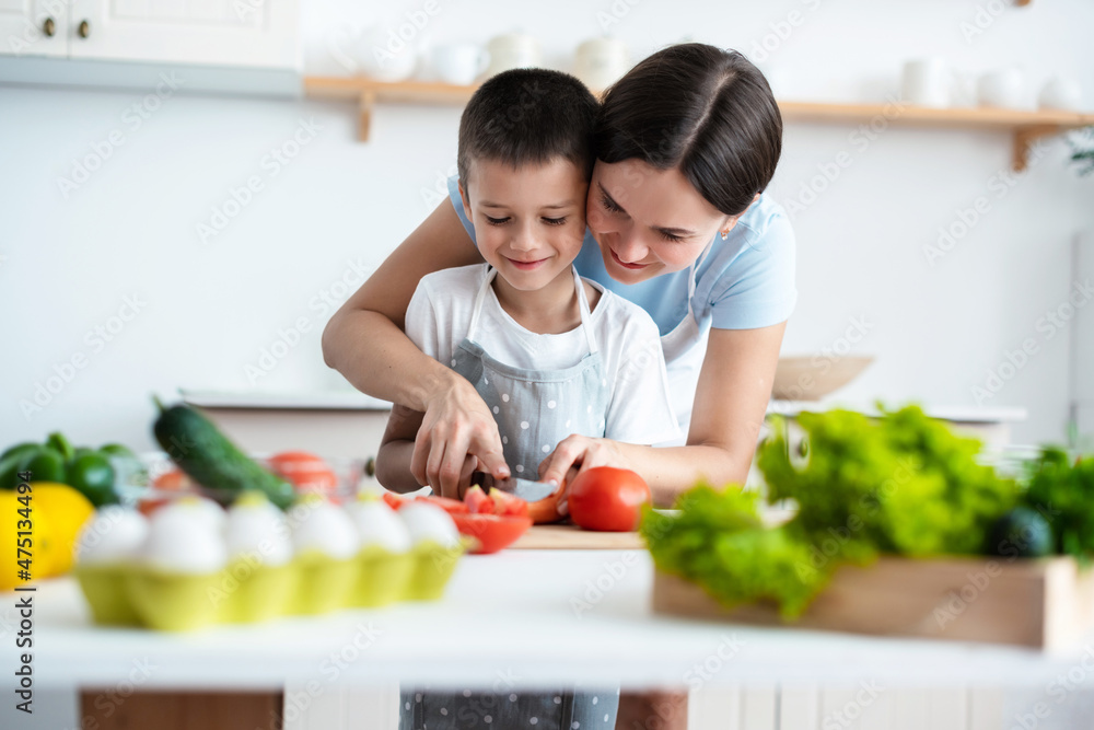 Cheerful mother helping her son to cook Cheerful mother helping her son to cook