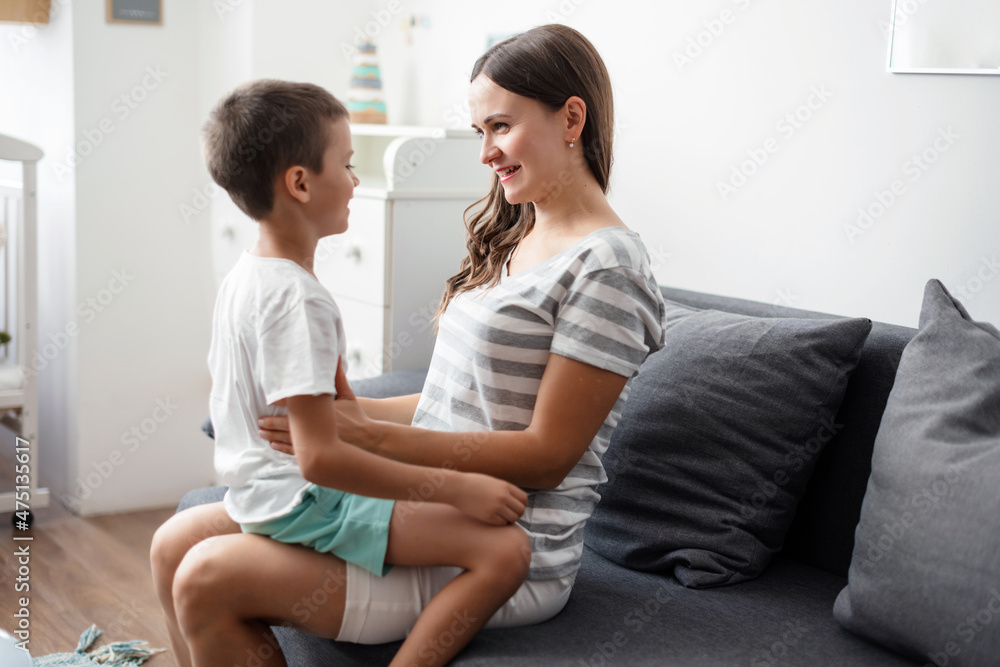 Cute funny child son embracing mother holding tight feeling love Cute funny child son embracing mother holding tight feeling love