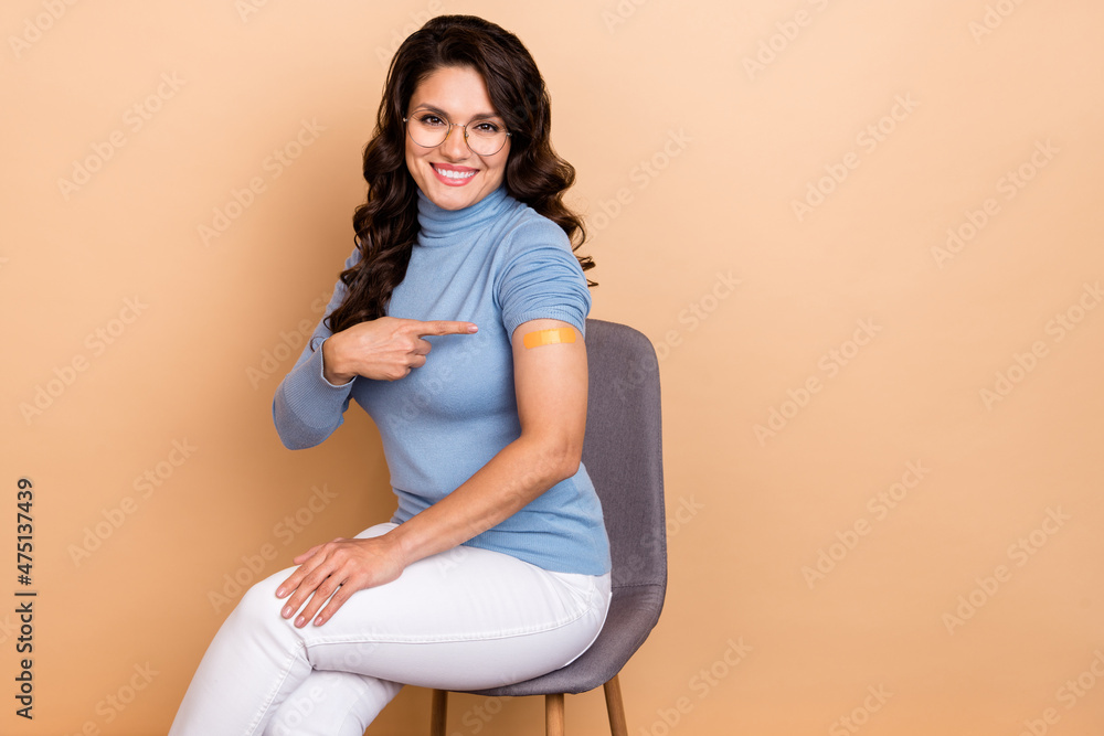 Photo of cute pretty woman wear blue sweater spectacles pointing patch sticky plaster isolated beige color background Photo of cute pretty woman wear blue sweater spectacles pointing patch sticky plaster isolated beige color background