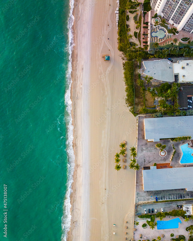 epic drone top down view of shore line at miami beach with beautiful water