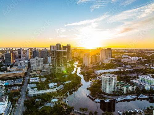 epic wide capture of city with large river running through it during sunrise