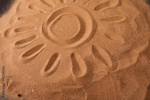 .Sun Drawn in the Sand on a Beach