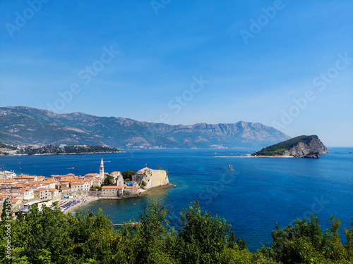 The view of St. Nicholas Island and Budva medieval fortress of St. Mary, Citadel, landscape of Old town Budva, Montenegro, beautiful seascape