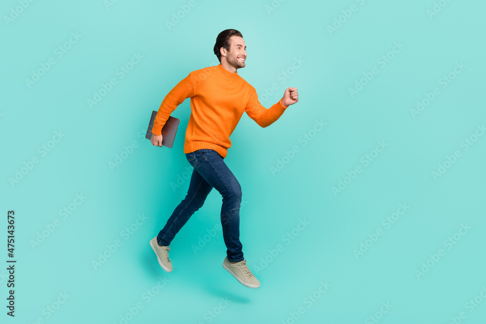 Full size profile photo of handsome active guy hurry look empty space isolated on turquoise color background Full size profile photo of handsome active guy hurry look empty space isolated on turquoise color background