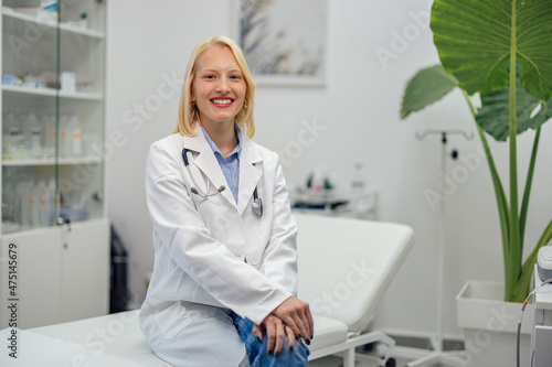 Portrait of young caucasian doctor, opening her own clinic and smiling.