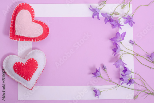 Valentines day card with copy space, white frame on lilac background with hearts and flowers