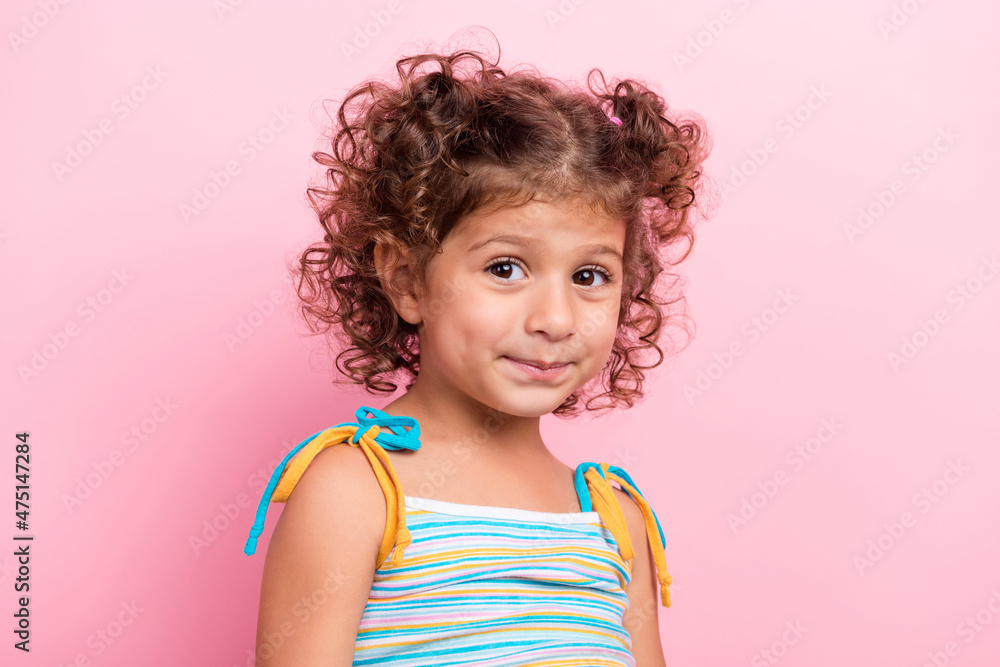Portrait of attractive cheerful shy wavy-haired preteen girl summer season isolated over pink pastel color background