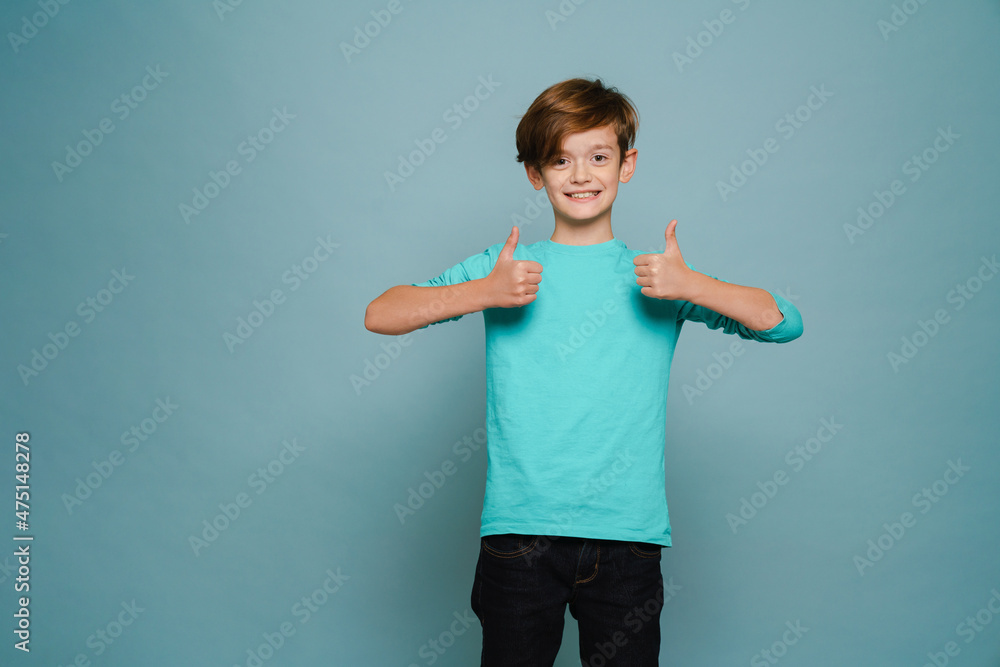 Ginger white boy wearing long sleeve smiling and showing thumbs up Ginger white boy wearing long sleeve smiling and showing thumbs up