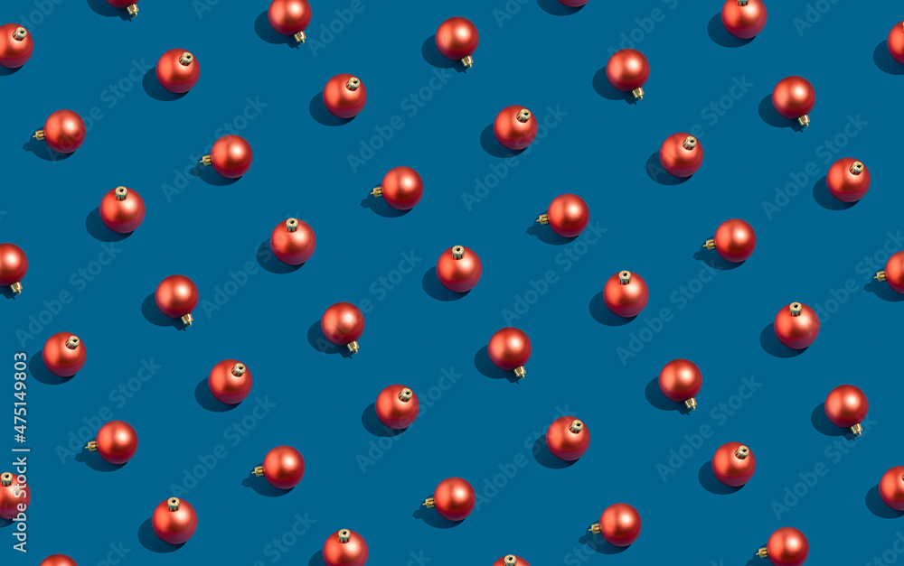 Holiday celebration and winter pattern idea with red baubles on blue background. Minimal visual composition, New Year and Christmas decoration concept. Holiday celebration and winter pattern idea with red baubles on blue background. Minimal visual composition, New Year and Christmas decoration concept.