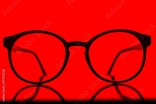 Fototapeta Naklejka Na Ścianę i Meble -  Black glasses isolated on red background set of mathematical formulas