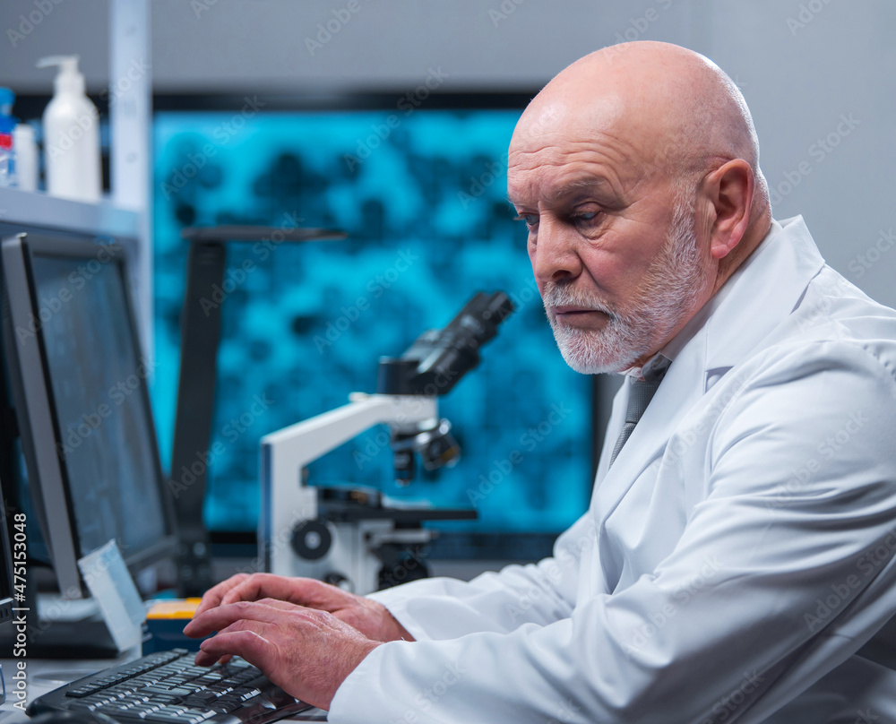 Professor works in a modern scientific laboratory using equipment and computer technologies. The scientist does research and develops new vaccines. Science and healthcare concept. Professor works in a modern scientific laboratory using equipment and computer technologies. The scientist does research and develops new vaccines. Science and healthcare concept.
