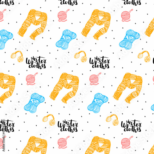 Vector pattern with lettering Winter Clothes, clothing elements, knitted scarf, earmuffs, skein of yarn, wool threads, crochet hook. Background of falling snowflakes.