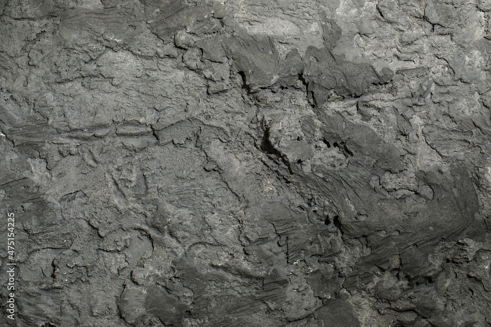 Grey textured clay wall design with cracks and imperfections. Wall design ideas in contemporary interior. Grey textured clay wall design with cracks and imperfections. Wall design ideas in contemporary interior.