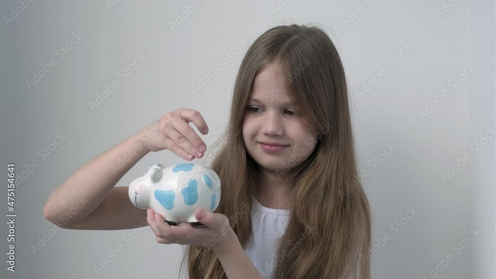 Little girl putting coins into cow piggy bank. Learning financial responsibility and projecting savings. Saving money for the future, investment concept. Planning for support. Donation contribution. Little girl putting coins into cow piggy bank. Learning financial responsibility and projecting savings. Saving money for the future, investment concept. Planning for support. Donation contribution.